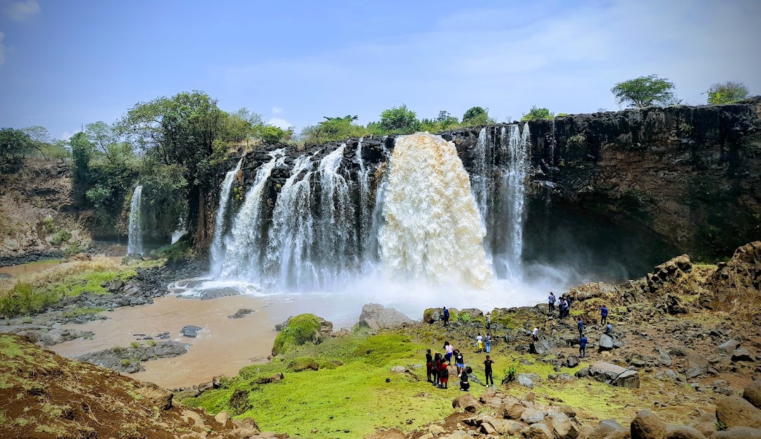 Blue Nile Falls with visitors at the base.